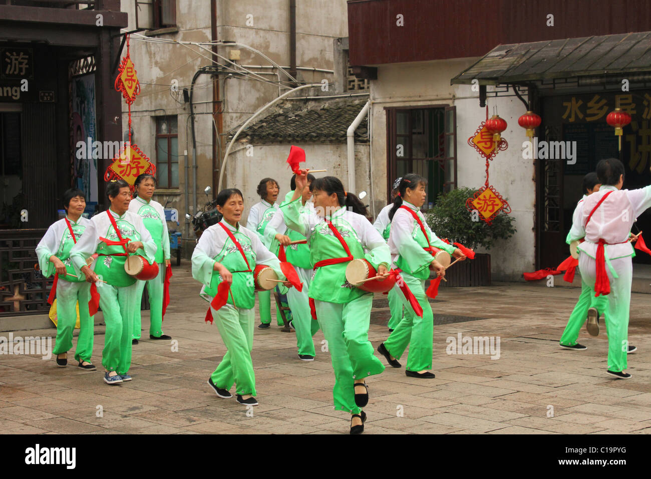 Chinese women doing drum and dance exhibition. ZhouZhuang historic water town, Jiangsu, China. Stock Photo