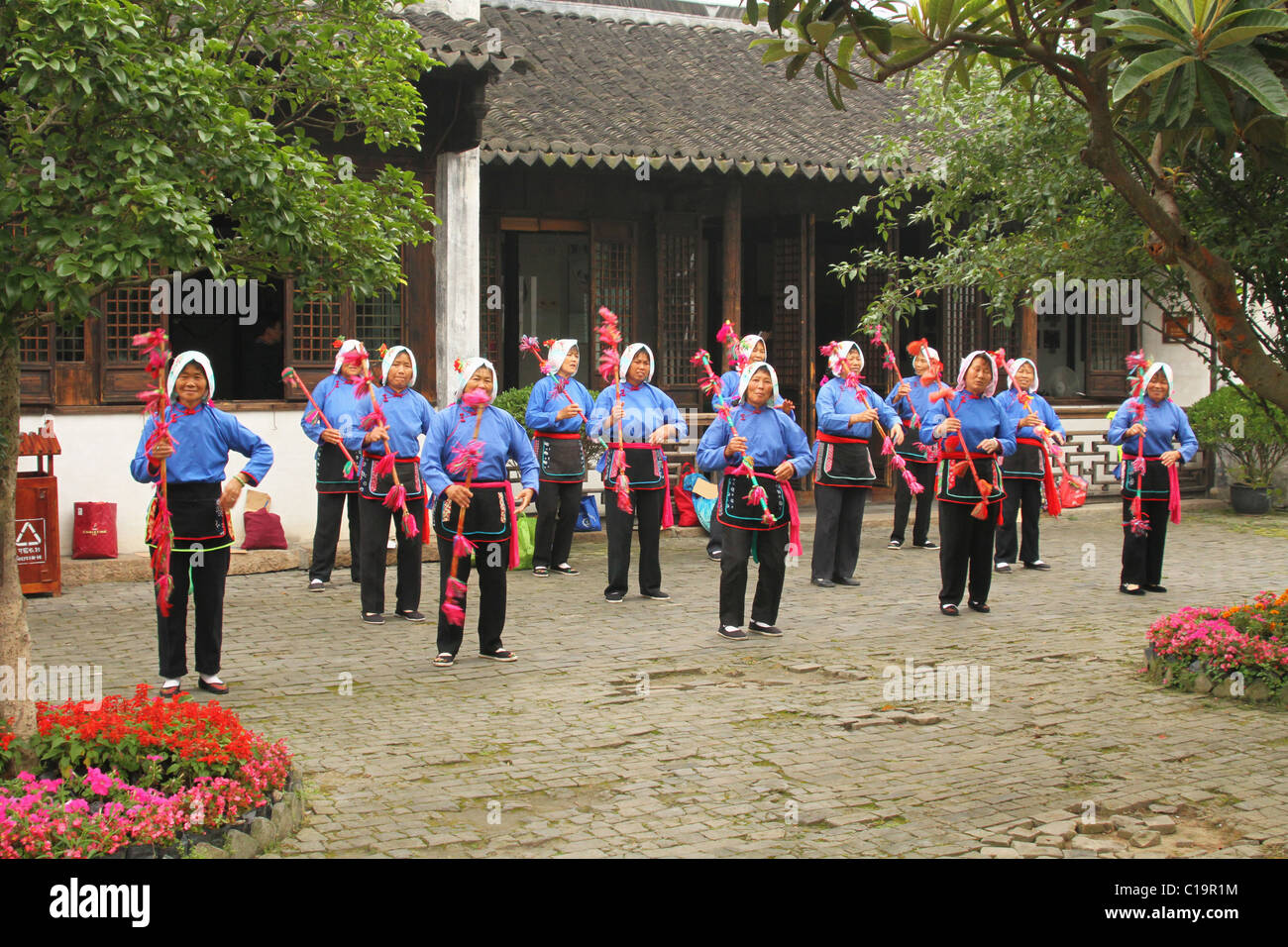 Chinese women doing a dance exhibition. ZhouZhuang historic water town, Jiangsu, China. Stock Photo