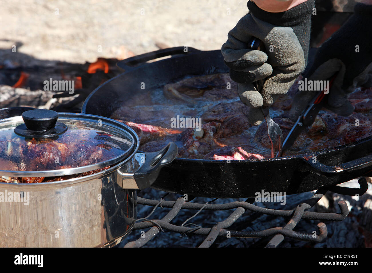 Steak meat Mutton Lamb steaks and chops cooking over fire in cast iron ...