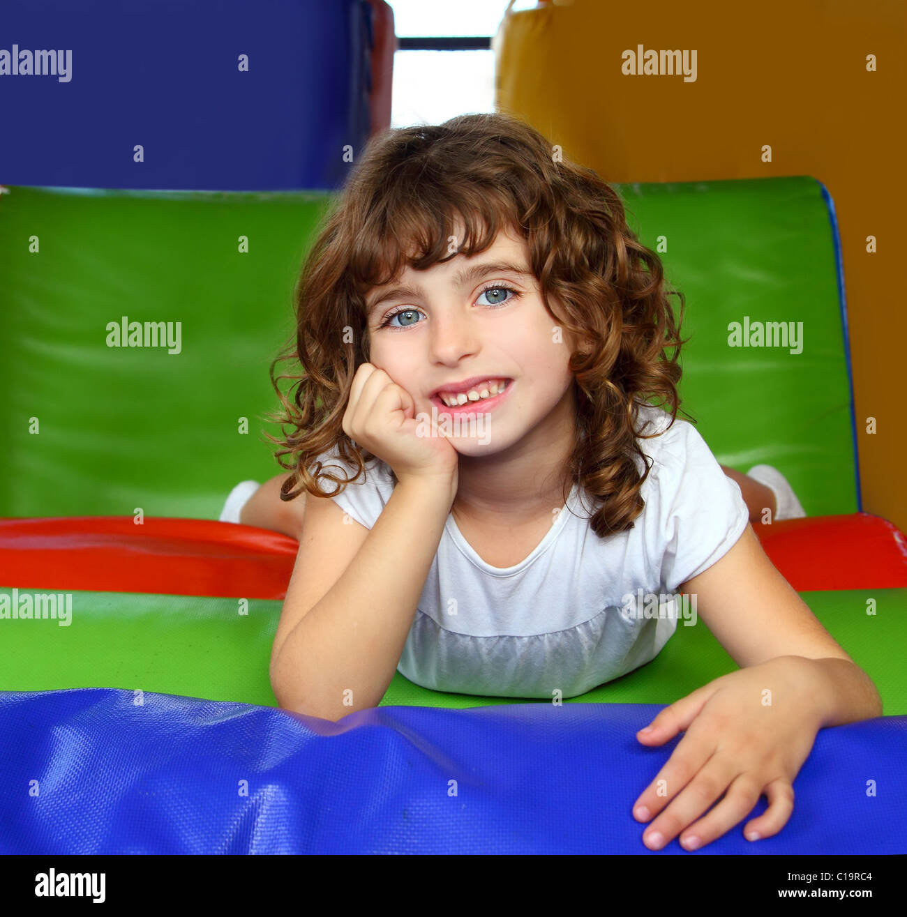 brunette little girl portrait posing in playground colorful Stock Photo ...