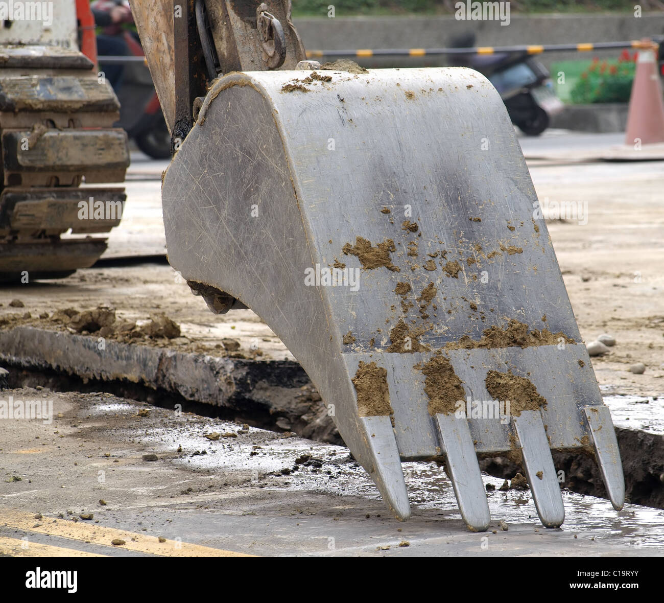 The digging bucket of a backhoe next to a ditch Stock Photo Alamy