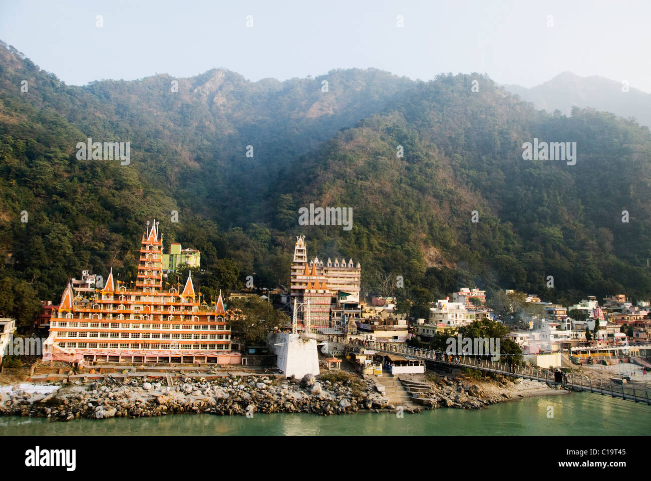 Temples at the riverbank, Swarg Niwas Temple, Lakshman Jhula, Ganges River, Rishikesh, Uttarakhand, India Stock Photo