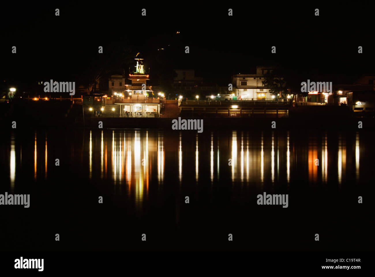 Reflection of buildings in water, Ganges River, Rishikesh, Uttarakhand, India Stock Photo