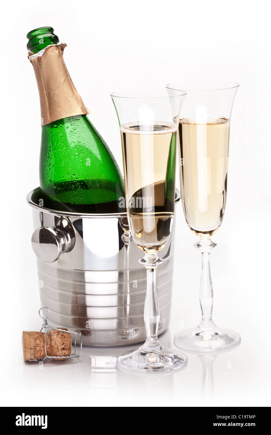Champagne bottle in cooler and two champagne glasses. Isolated on a white. Stock Photo