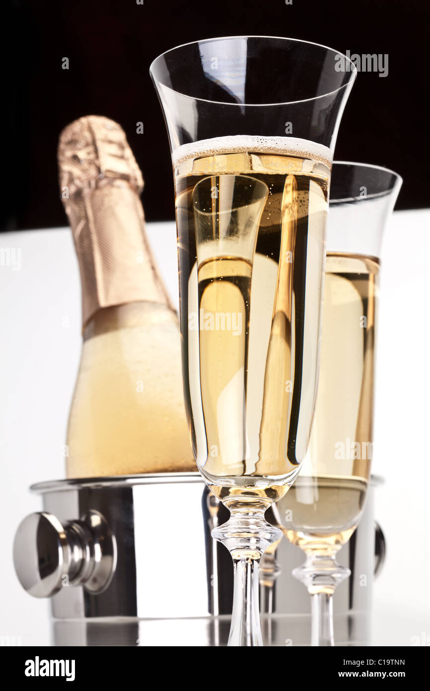 Champagne bottle in cooler and two champagne glasses. Stock Photo