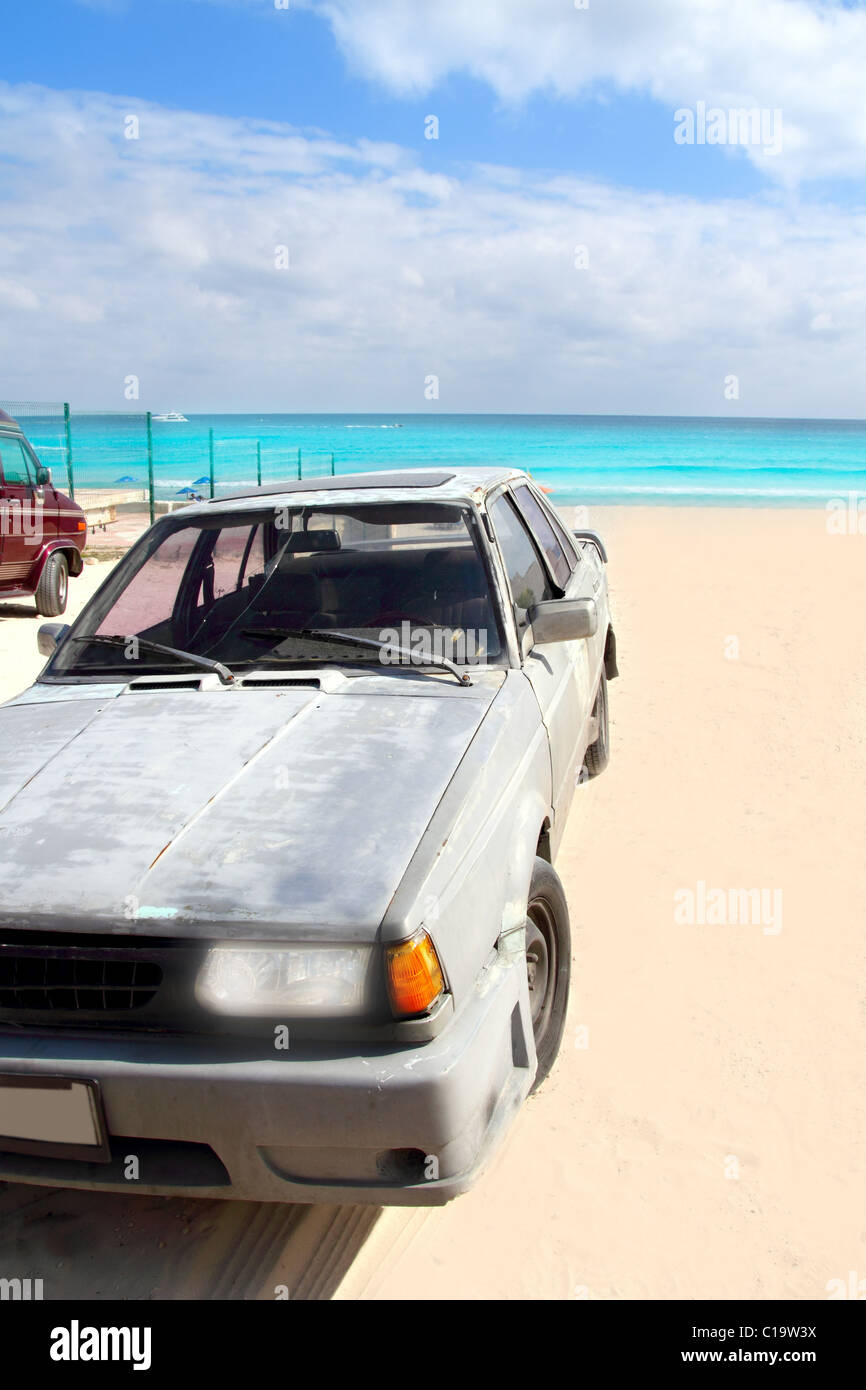 aged grunge car in Mexico Caribbean turquoise beach Stock Photo
