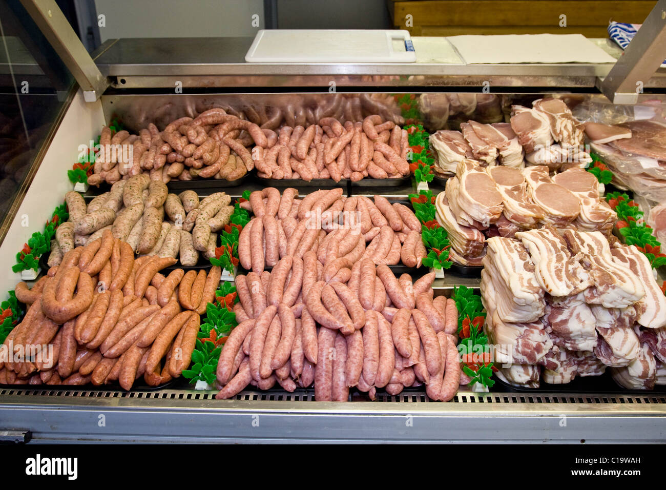 Sausage and Bacon on display in a butchers shop Stock Photo