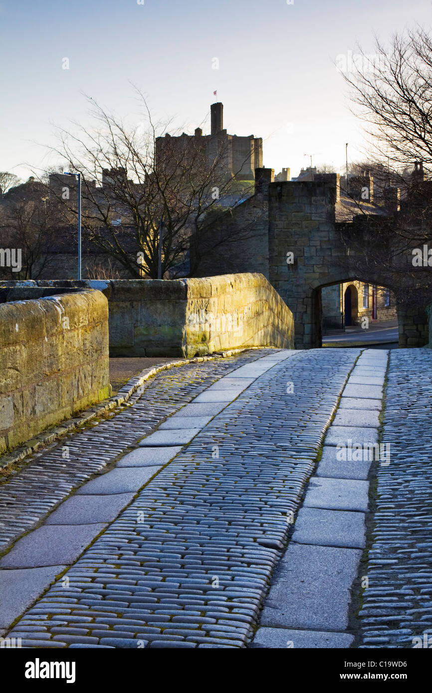 Warkworth Castle seen from the 14th century stone bridge over the River Coquet, Northumberland, England Stock Photo