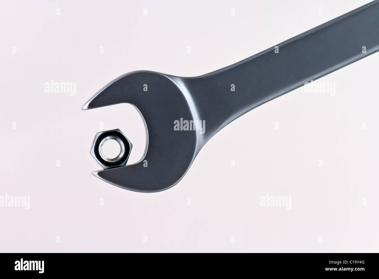 A too big wrench for nut. Symbolizing failure, problems, challenge or success. Stock Photo