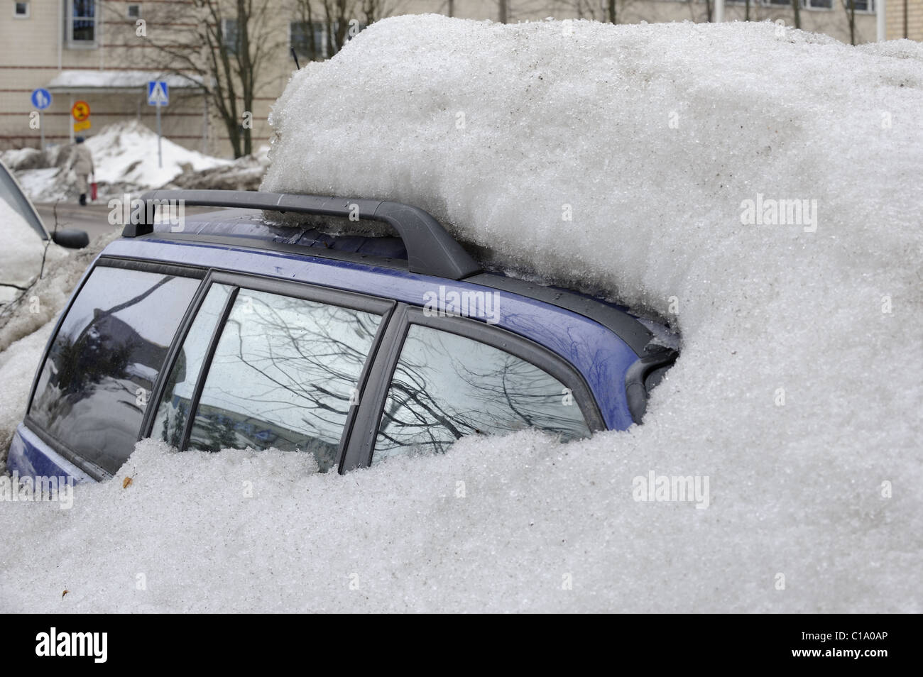 Some Finns do not use their cars during the wintertime. They just park their cars by the side of the street. Helsinki, Finland, Stock Photo