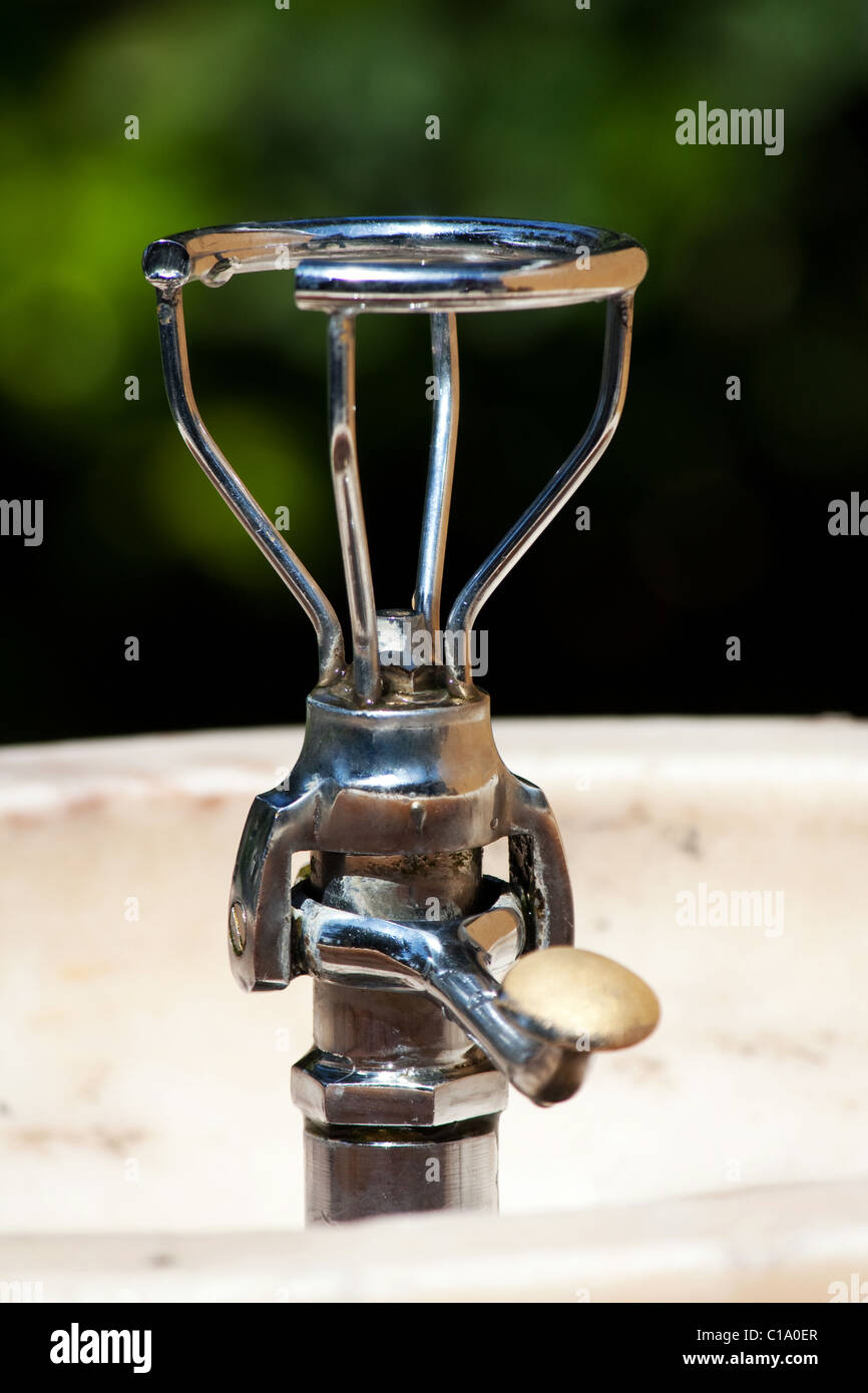 Closeup view of a drinkable public water fountain on a park. Stock Photo