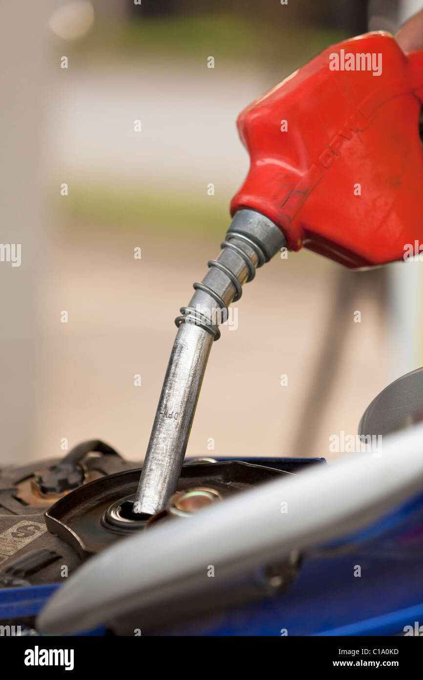 Filling up a motorbike with gasoline Stock Photo