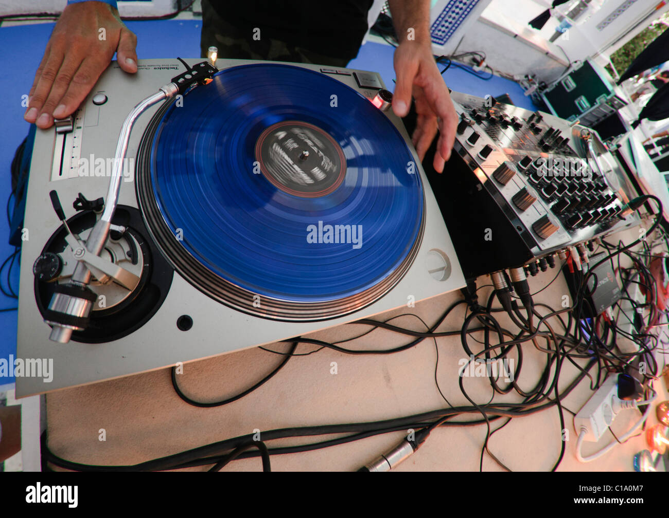 DJ performing live, mixing music using mixer and scratch vinyl record Stock Photo Alamy