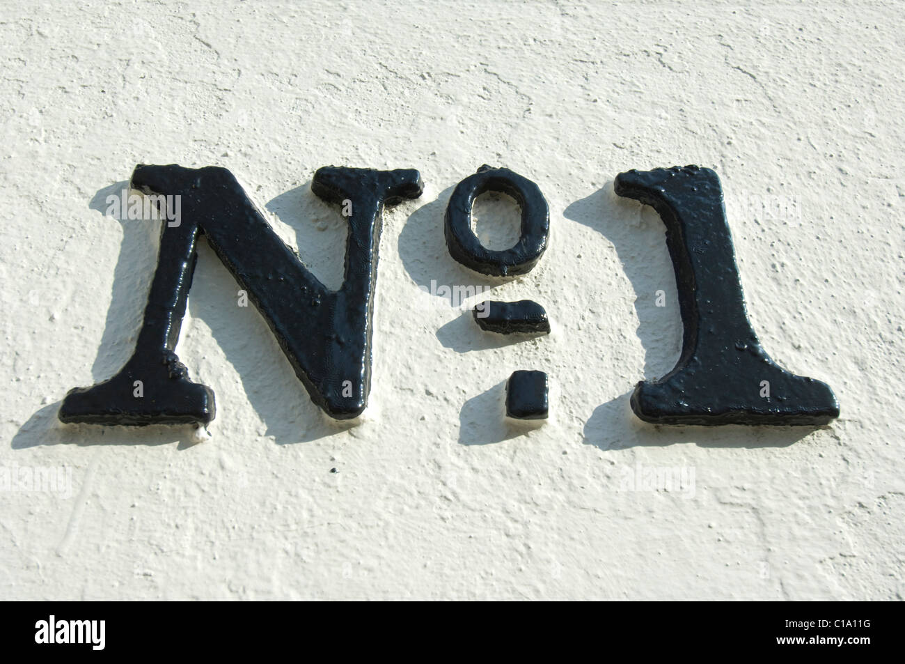 A black painted No 1 on the side of a Regency building in Brighton Sussex UK Stock Photo