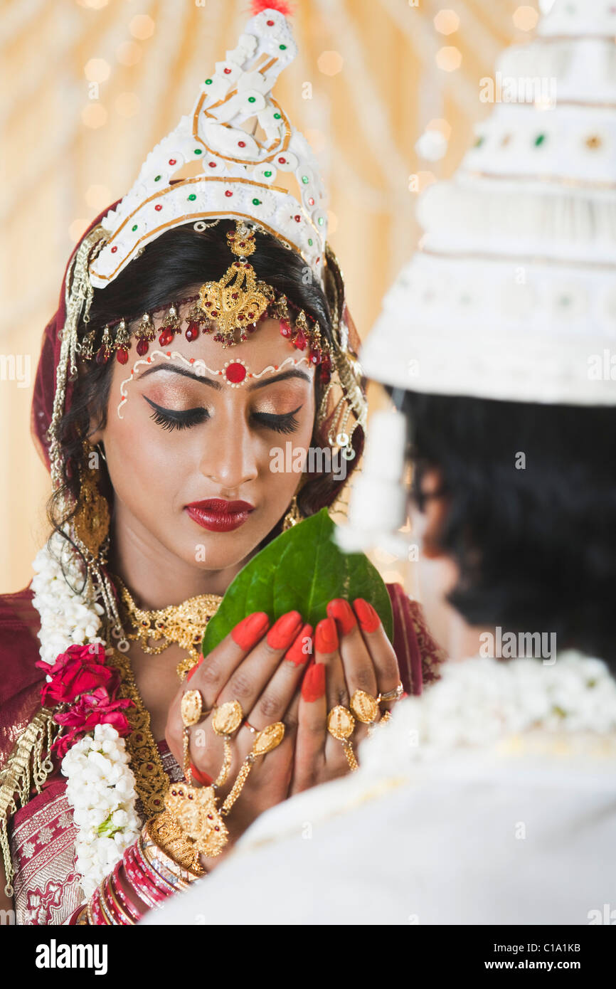 Couple giving Subho Drishti in Bengali wedding Stock Photo