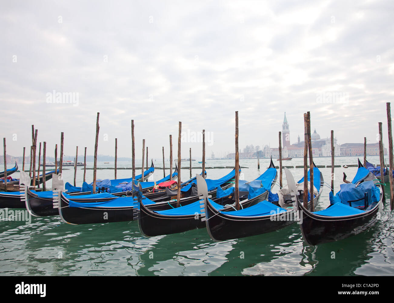 Gondolas with blue cover in Venice at the pier Stock Photo - Alamy
