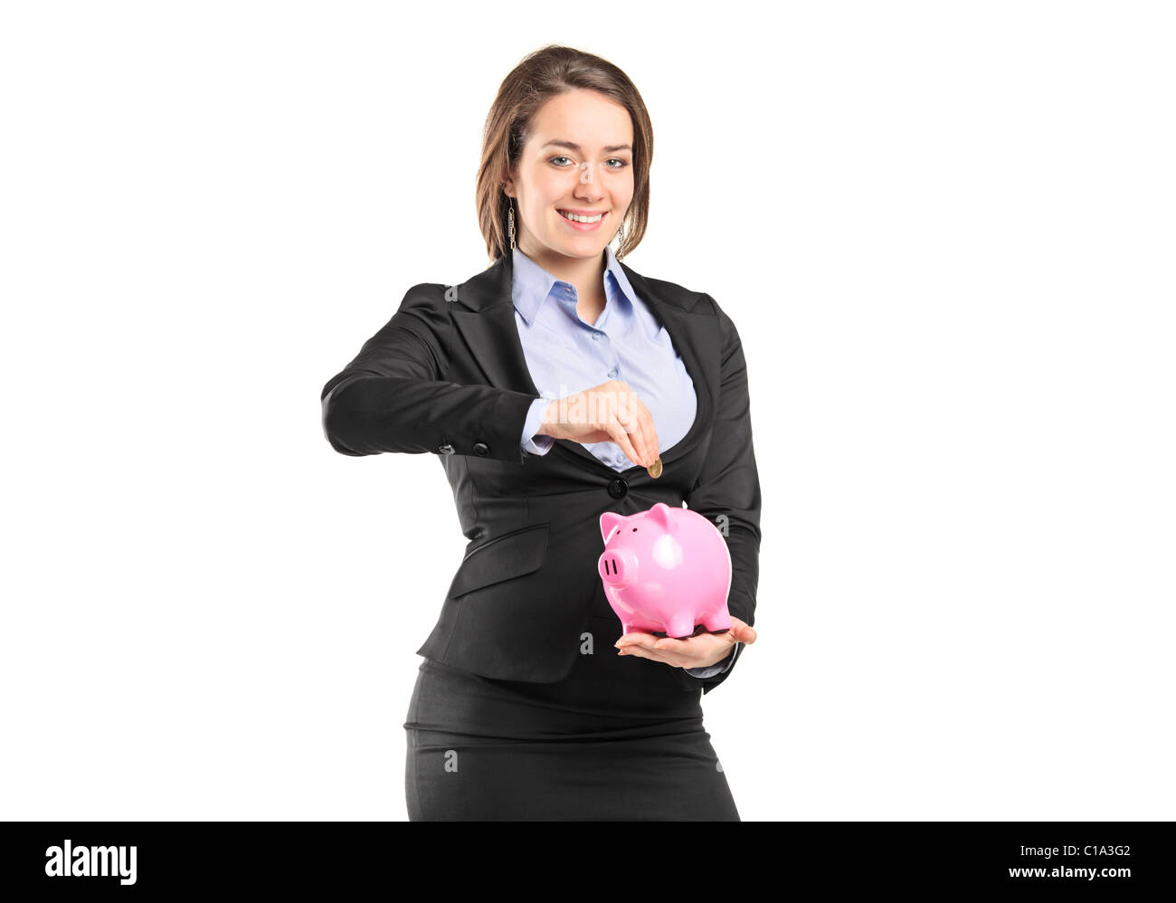 A businesswoman putting a coin into a piggy bank Stock Photo - Alamy