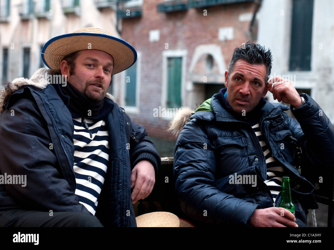 Two gondoliers awaiting customers, Venice, Italy Stock Photo