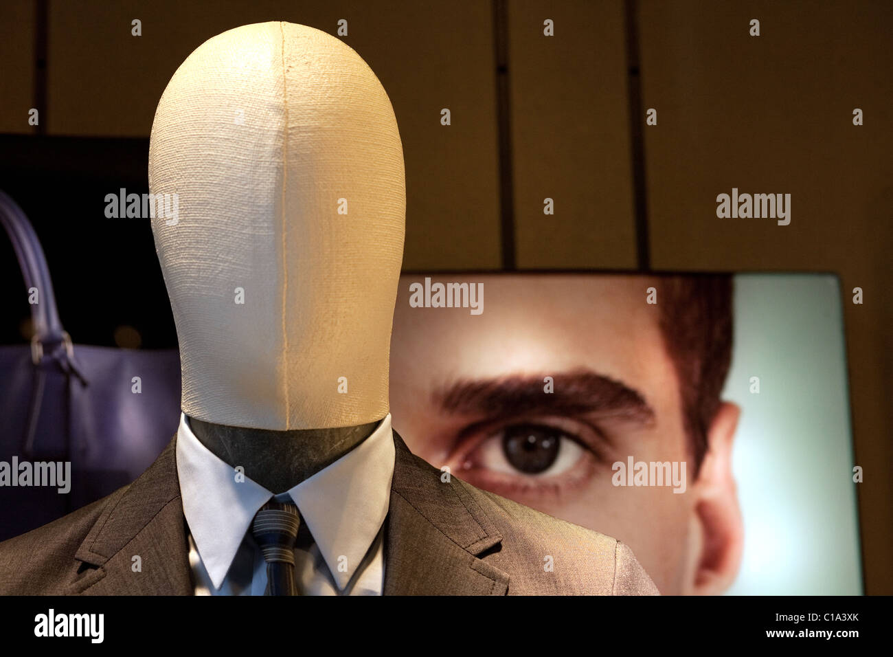 faceless shop window dummy and face peering over shoulder, Venice, Italy Stock Photo