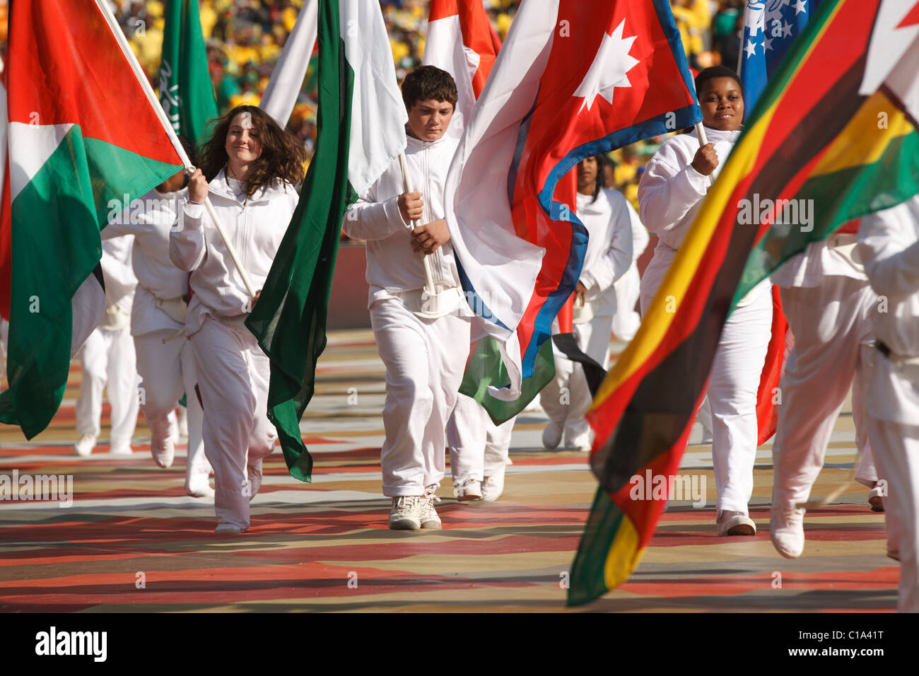 Children carry country flags as part of the opening ceremony of the 2010 FIFA World Cup soccer tournament June 11, 2010. Stock Photo