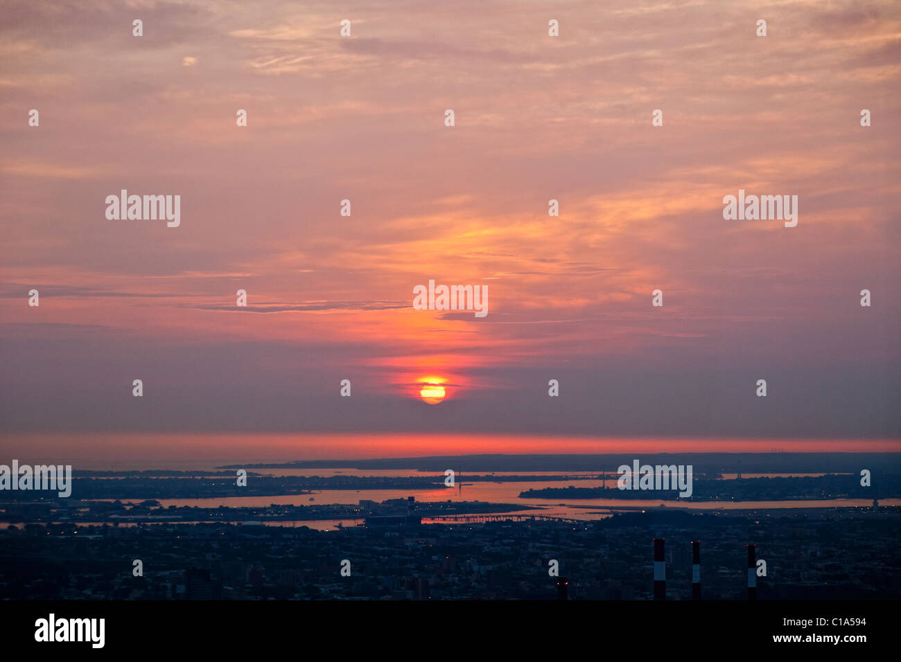 Distant view of sunrise on Long Island Sound from Manhattan. Stock Photo