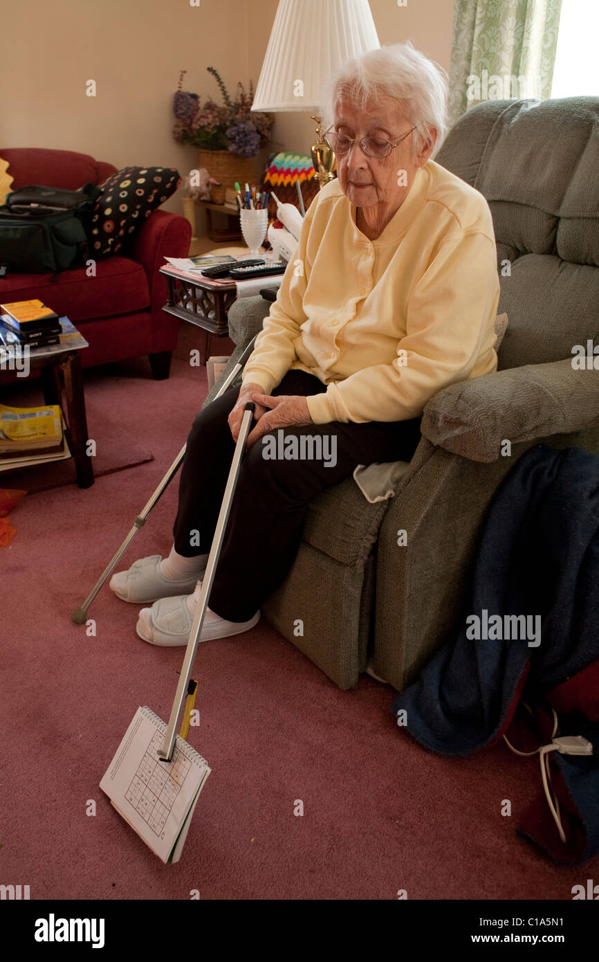 An elderly woman manages to take care of herself, living alone in her own home in Adams, Massachusetts.  MODEL RELEASE Stock Photo