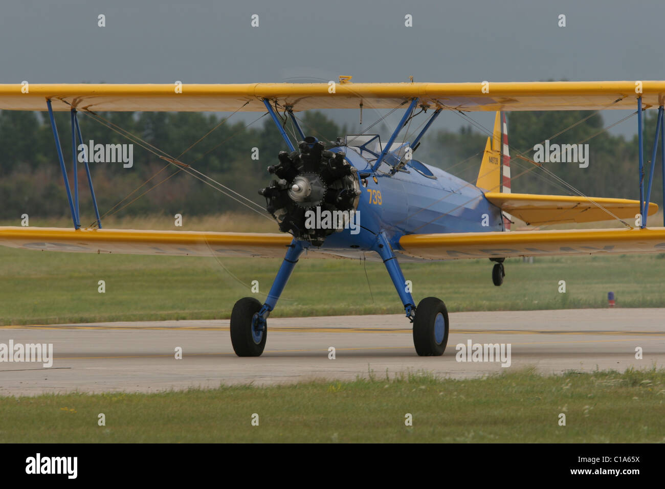 Boeing-Stearman Model 75 Kaydet, PT-13, WWII biplane primary trainer aircraft on takeoff roll, tail raised. Stock Photo