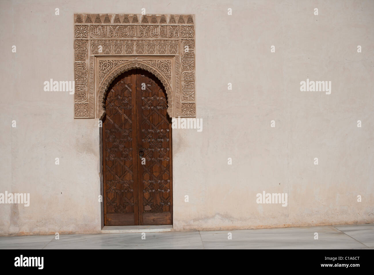 Textured carvings around doorway with Arabic carved themes, in the Alhambra Palace Granada, Spain Stock Photo