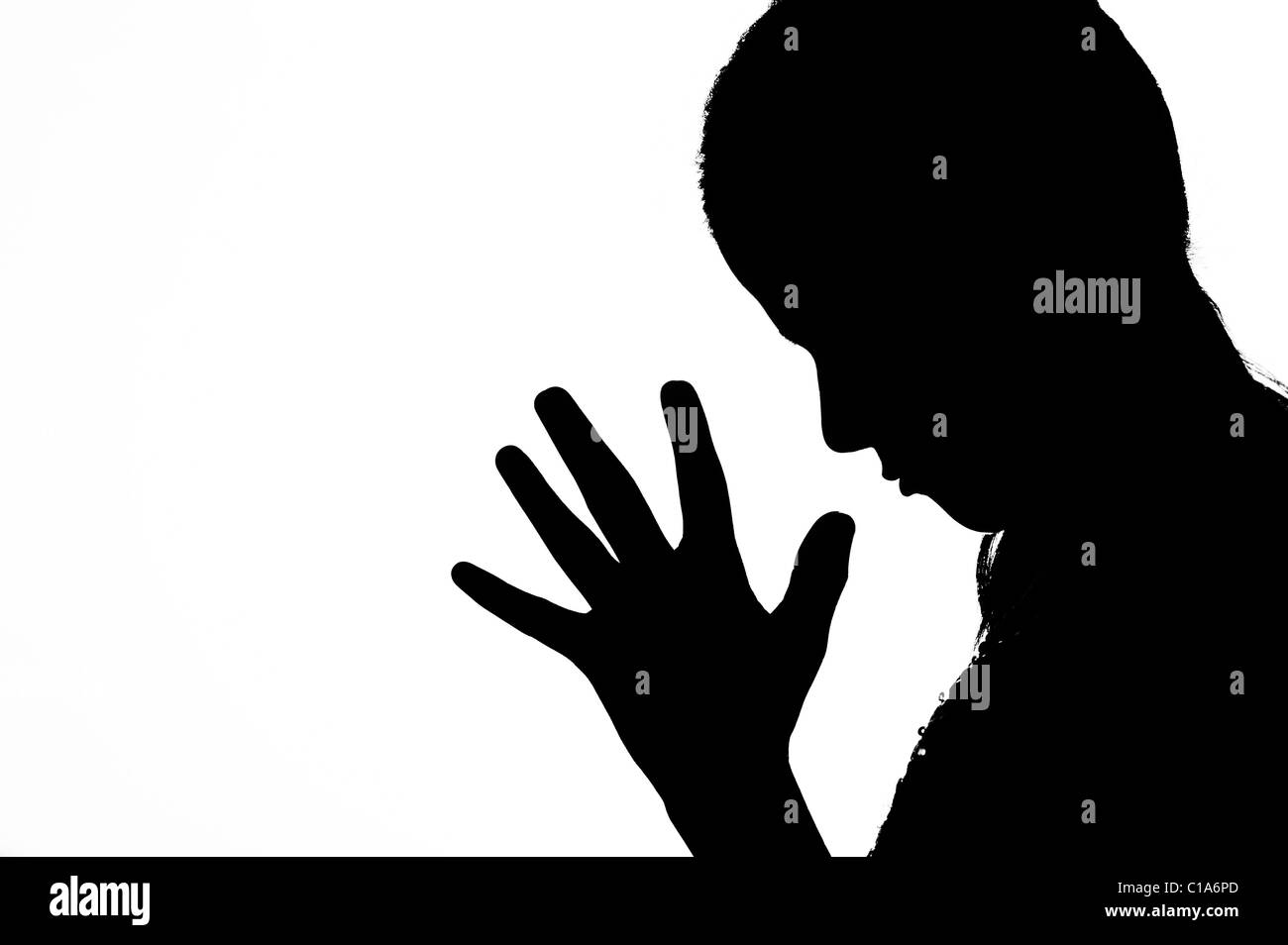 Indian girl praying. Silhouette. Black and white. India Stock Photo