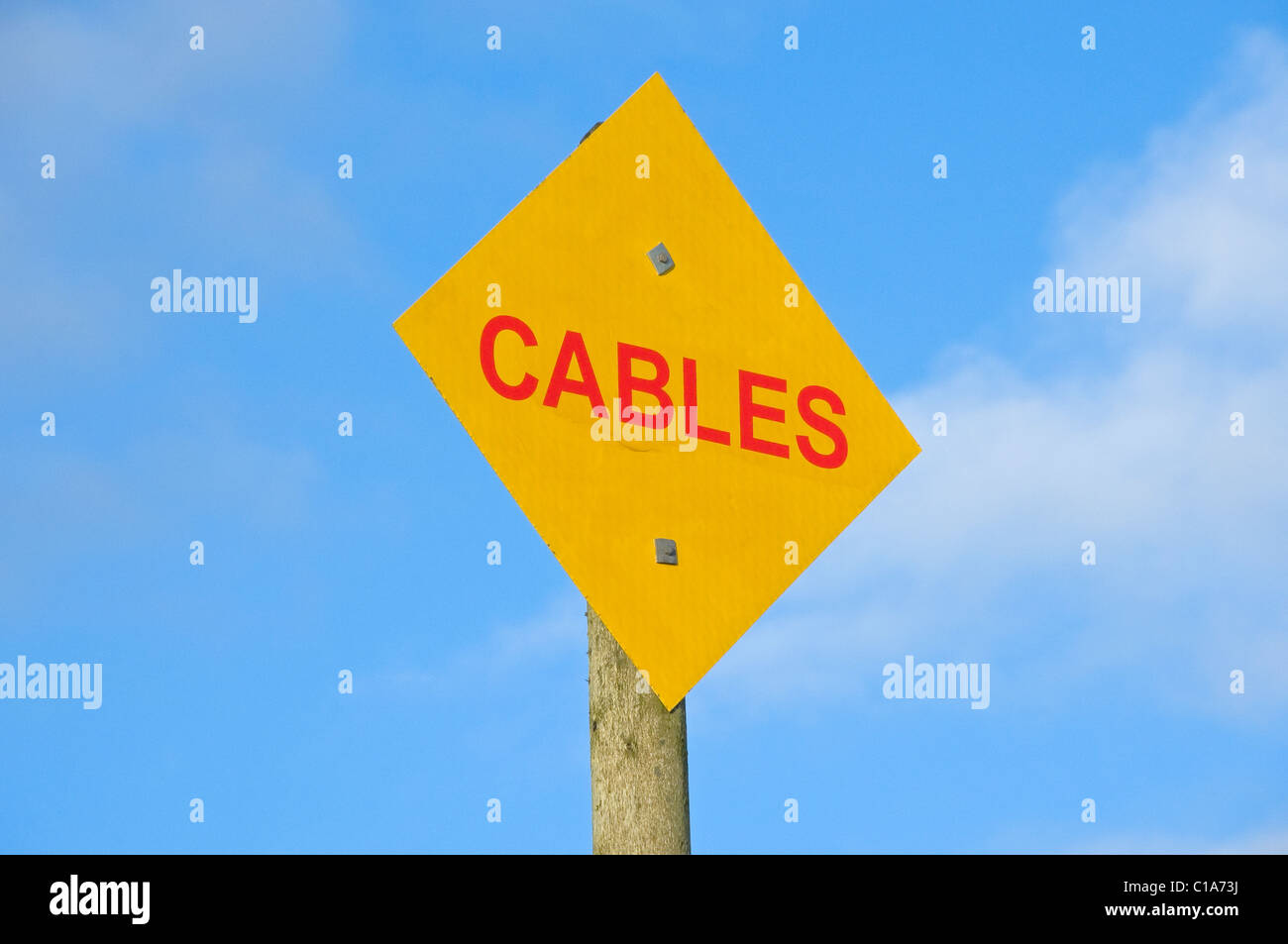 Close up of electric electricity power cable cables warning sign Wales UK United Kingdom GB Great Britain Stock Photo