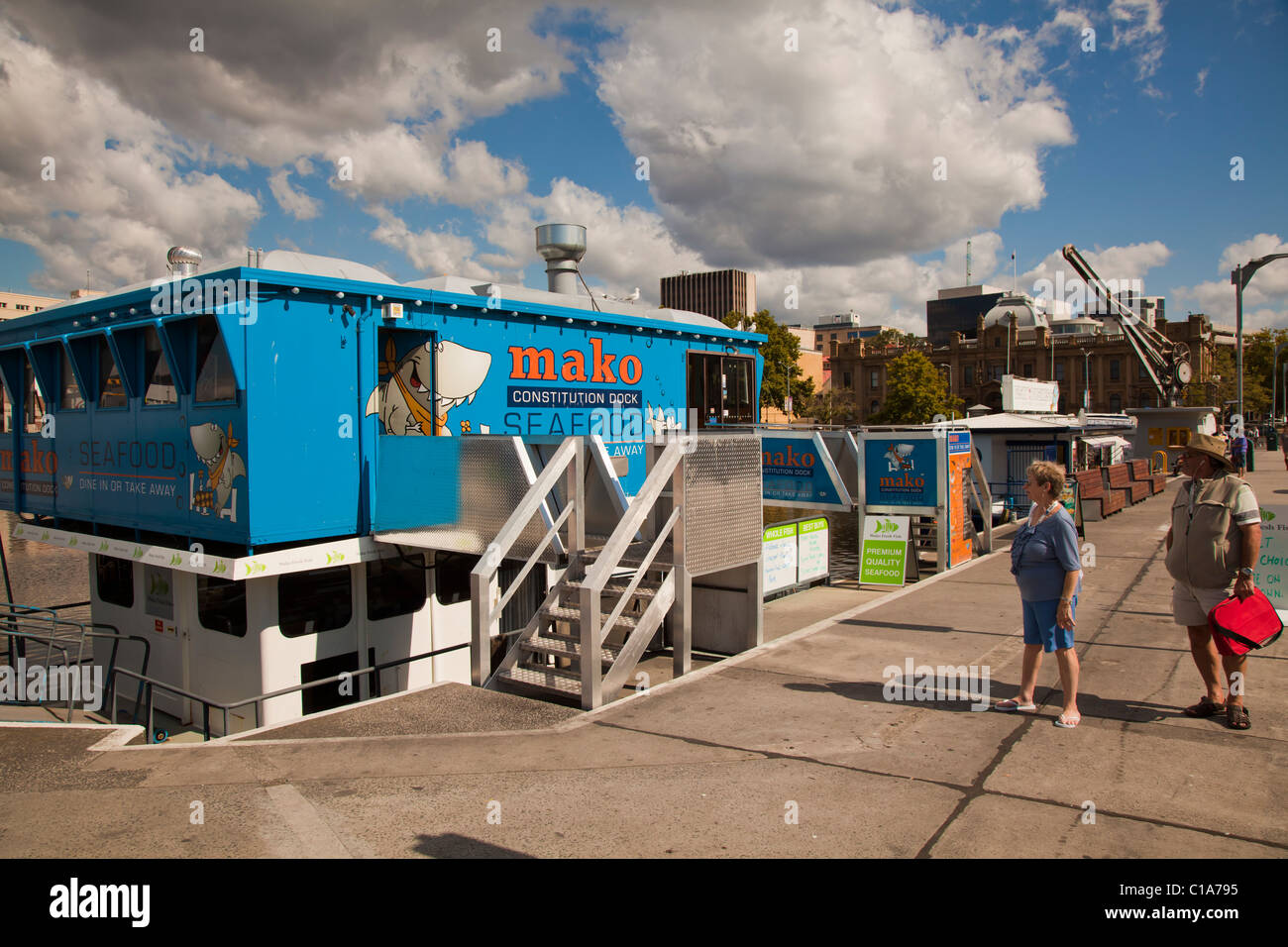 Tourists inspecting the waterfront seafood outlets on Constitution Dock