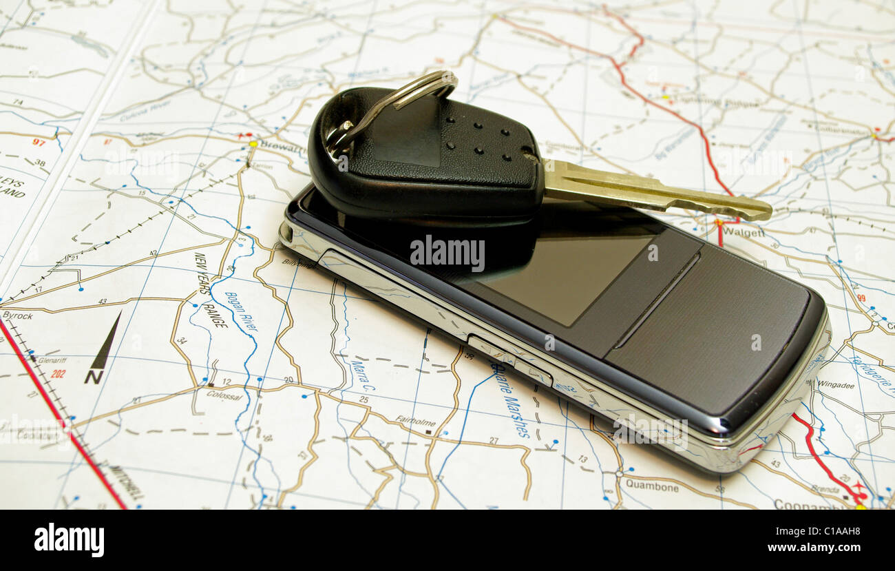 Mobile phone with car key on a road map Stock Photo