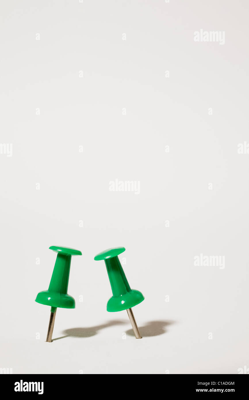 Two green thumbtacks Stock Photo