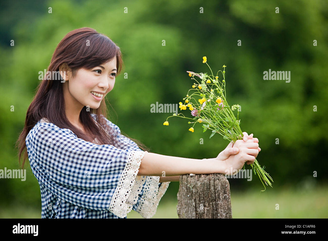 Woman holding bunch of wild flowers Stock Photo - Alamy