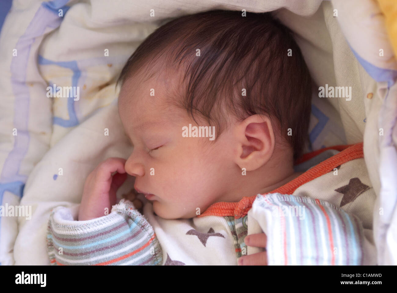 Baby girl sleeping in crib on quilt Stock Photo Alamy