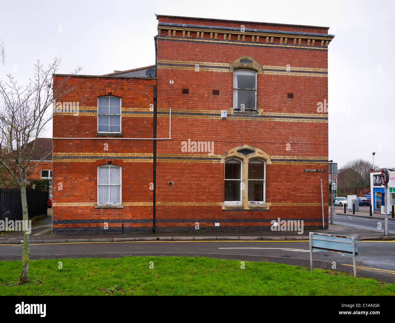 Side of a brick building, Mill House, in Albion Street, seen from Witcombe Place, Cheltenham, Gloucestershire, UK Stock Photo