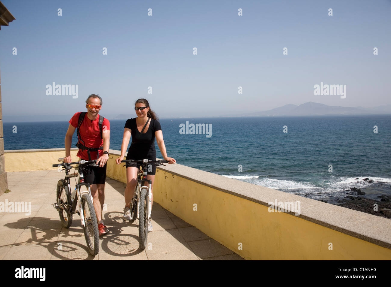 Spain  Fuerteventura Isla de los Lobos Cyclists Stock Photo