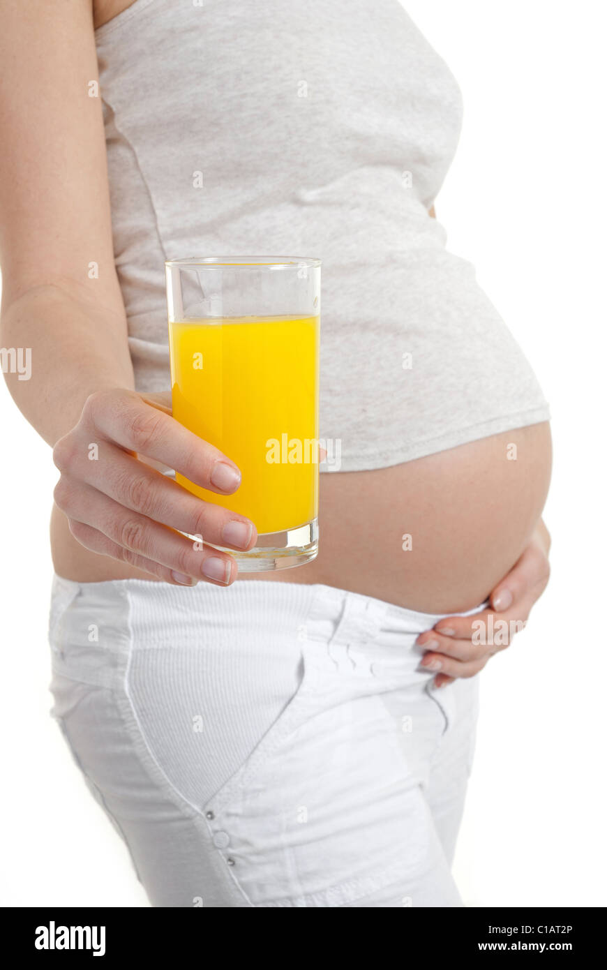 Pregnant woman holding glass of orange juice Stock Photo Alamy