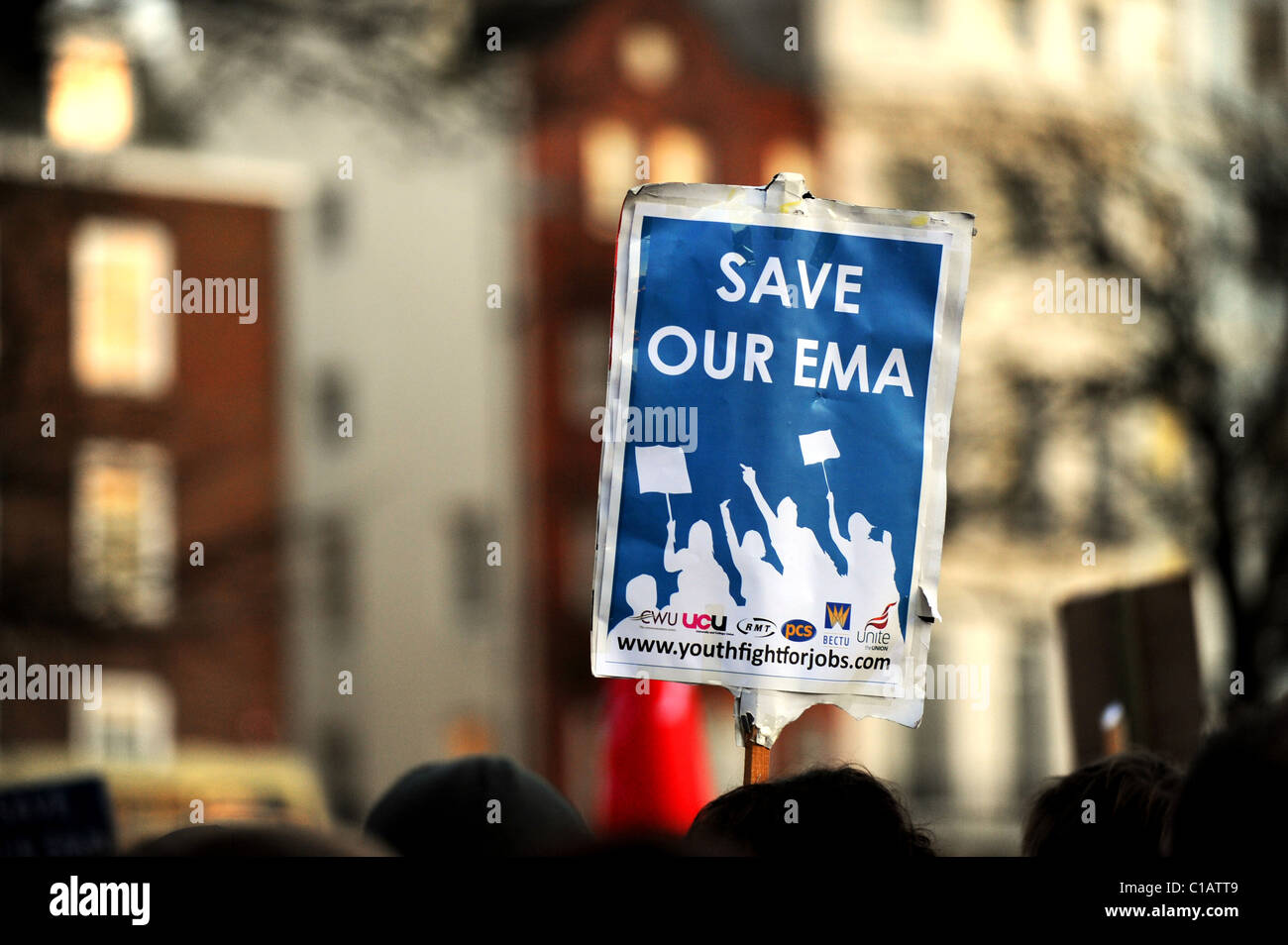 A student holds up a 'SAVE OUR EMA' placard during a protest held in Brighton Stock Photo