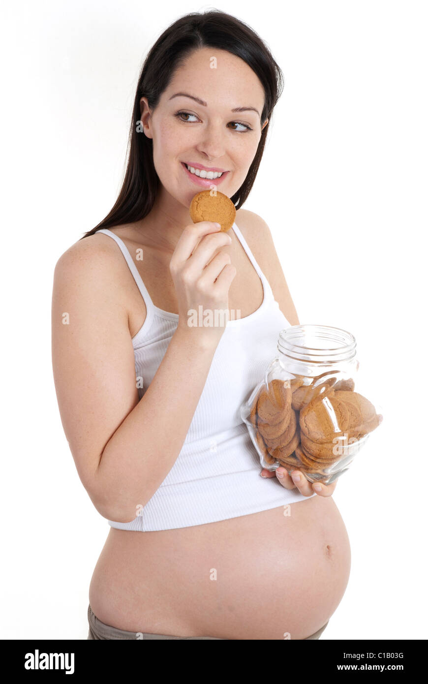 Pregnant woman eating biscuit Stock Photo Alamy