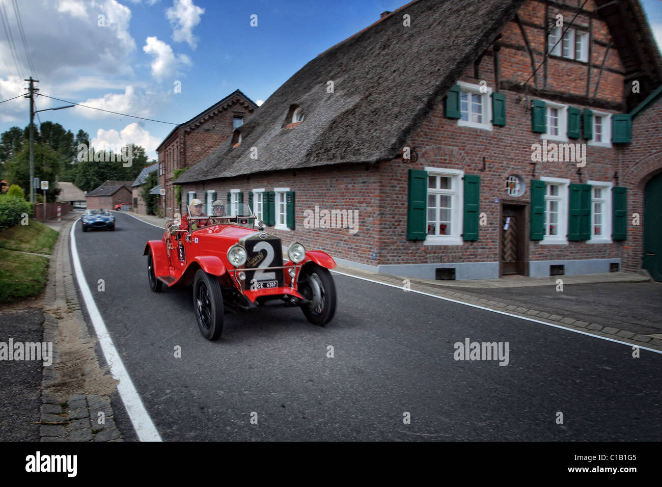 old timer race in front of old farm house in germany Stock Photo