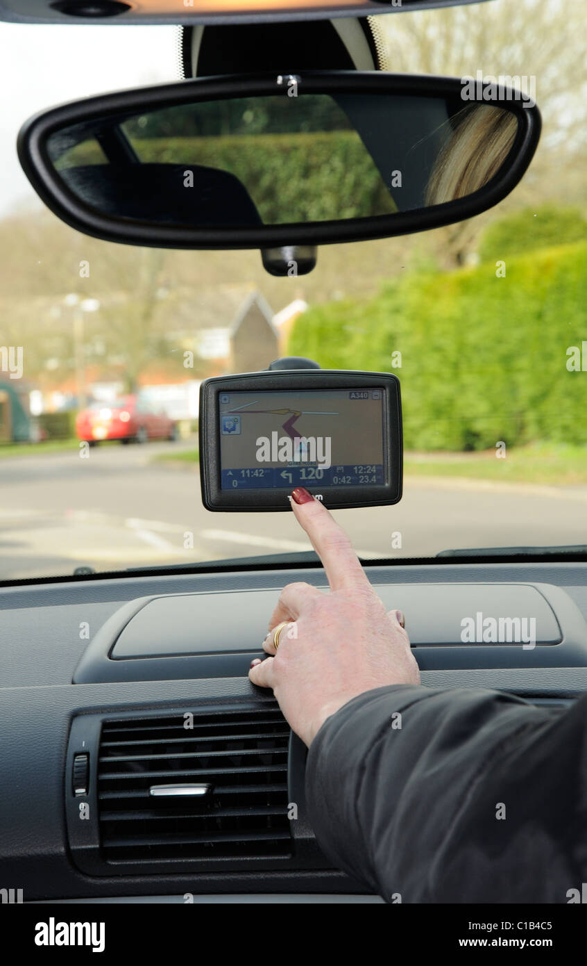 Woman driver using a TomTom Sat Nav device Stock Photo