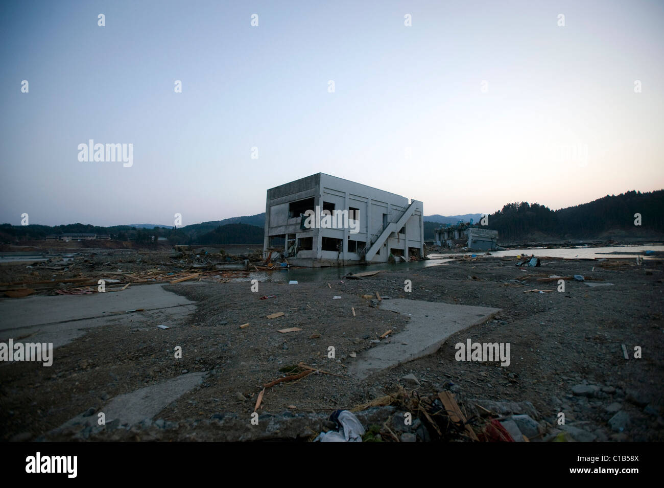 A building lies removed from its foundations after the mega-tsunami in Minami-Sanriku, Japan Stock Photo