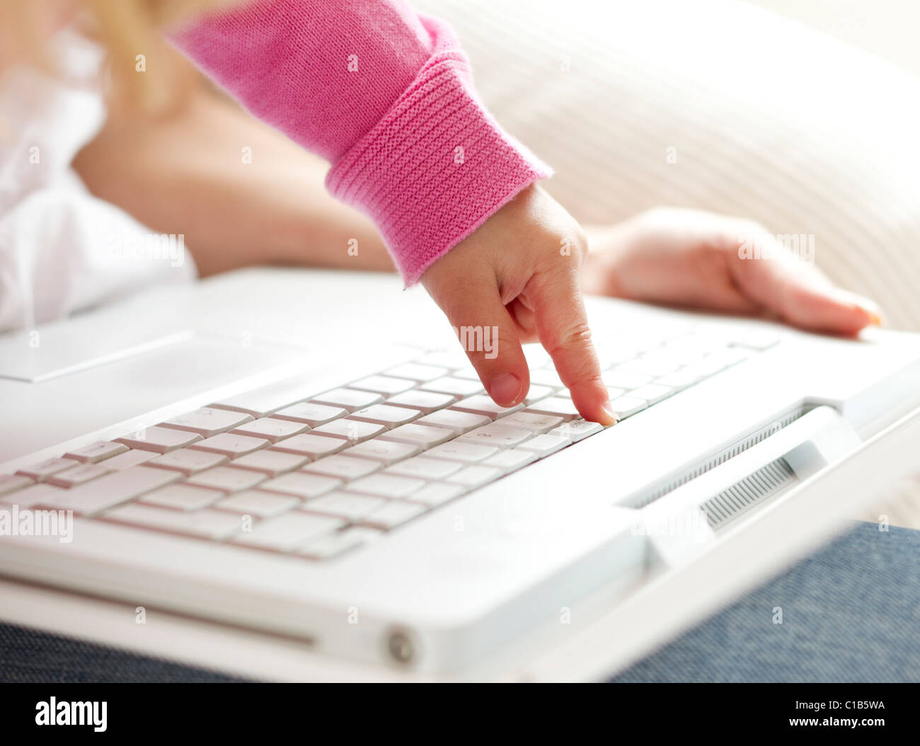 Child typing on keyboard Stock Photo Alamy