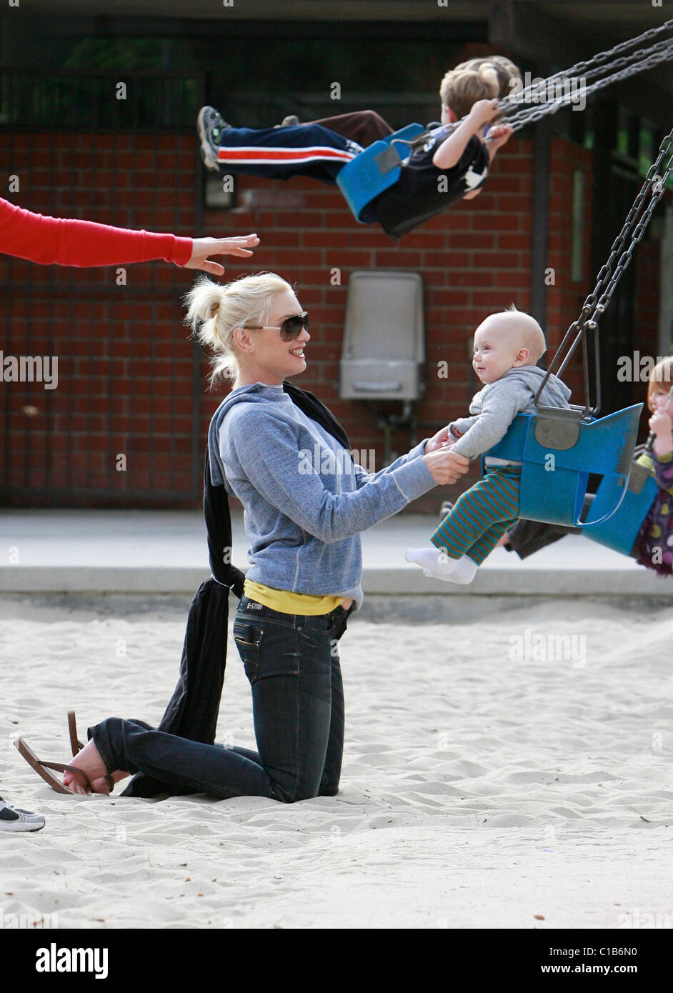 Gwen Stefani pushes baby Zuma in a swing as they spend the afternoon at