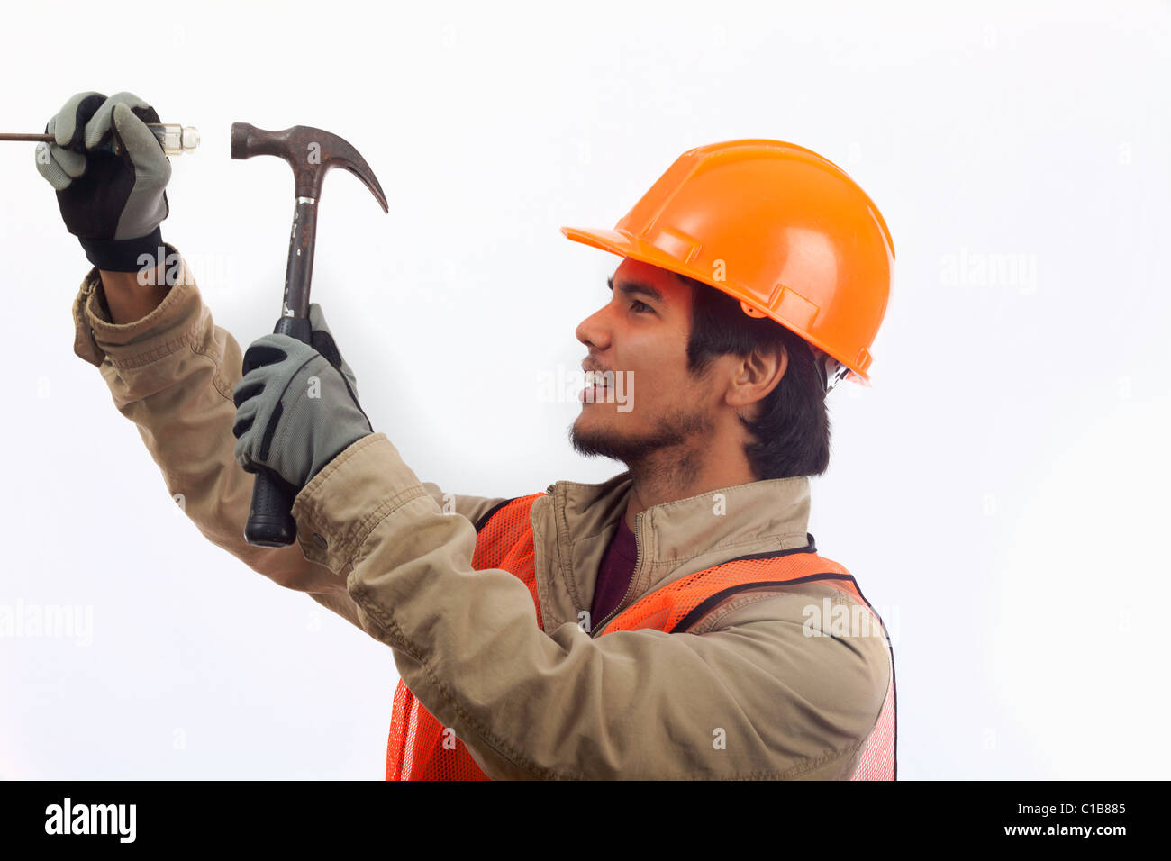 hard hat worker using a hammer Stock Photo Alamy