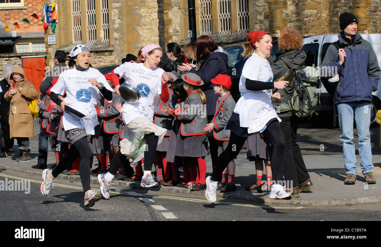 Pancake Race in Olney Buckinghamshire UK competitors race with their