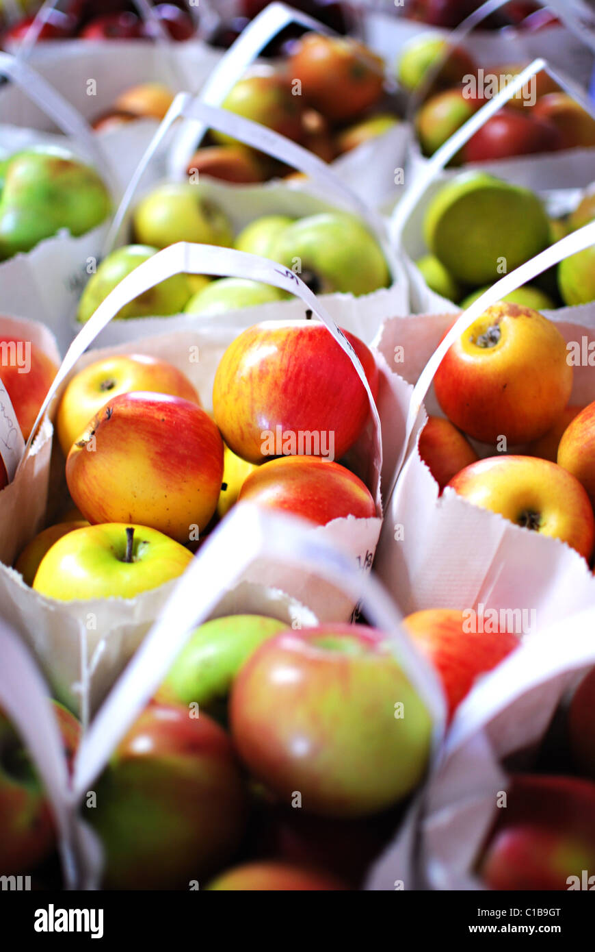 Apples for sale in bags at a local farmers market. Stock Photo
