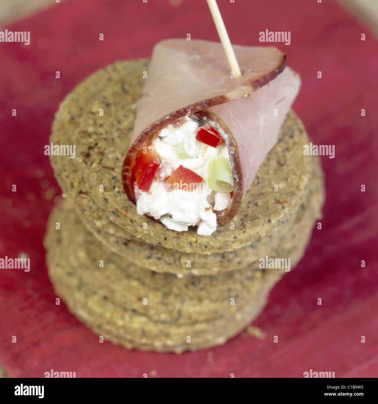 Oatcakes with smoked ham wrapped around cheesestuffed peppers, + spring onions Stock Photo Alamy
