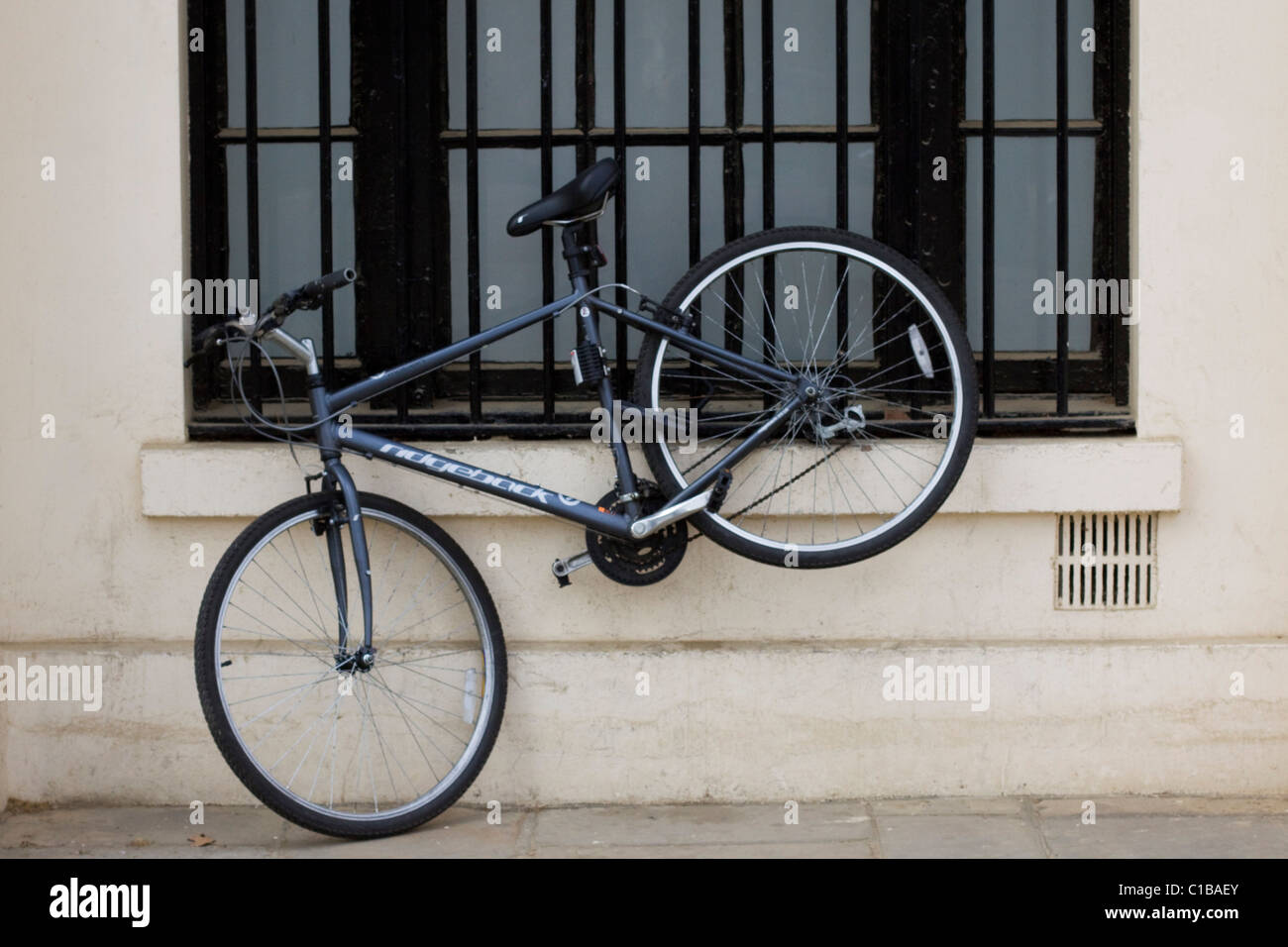 A Bicycle Chained to the side of a building on The Mall in the city of London England Stock Photo